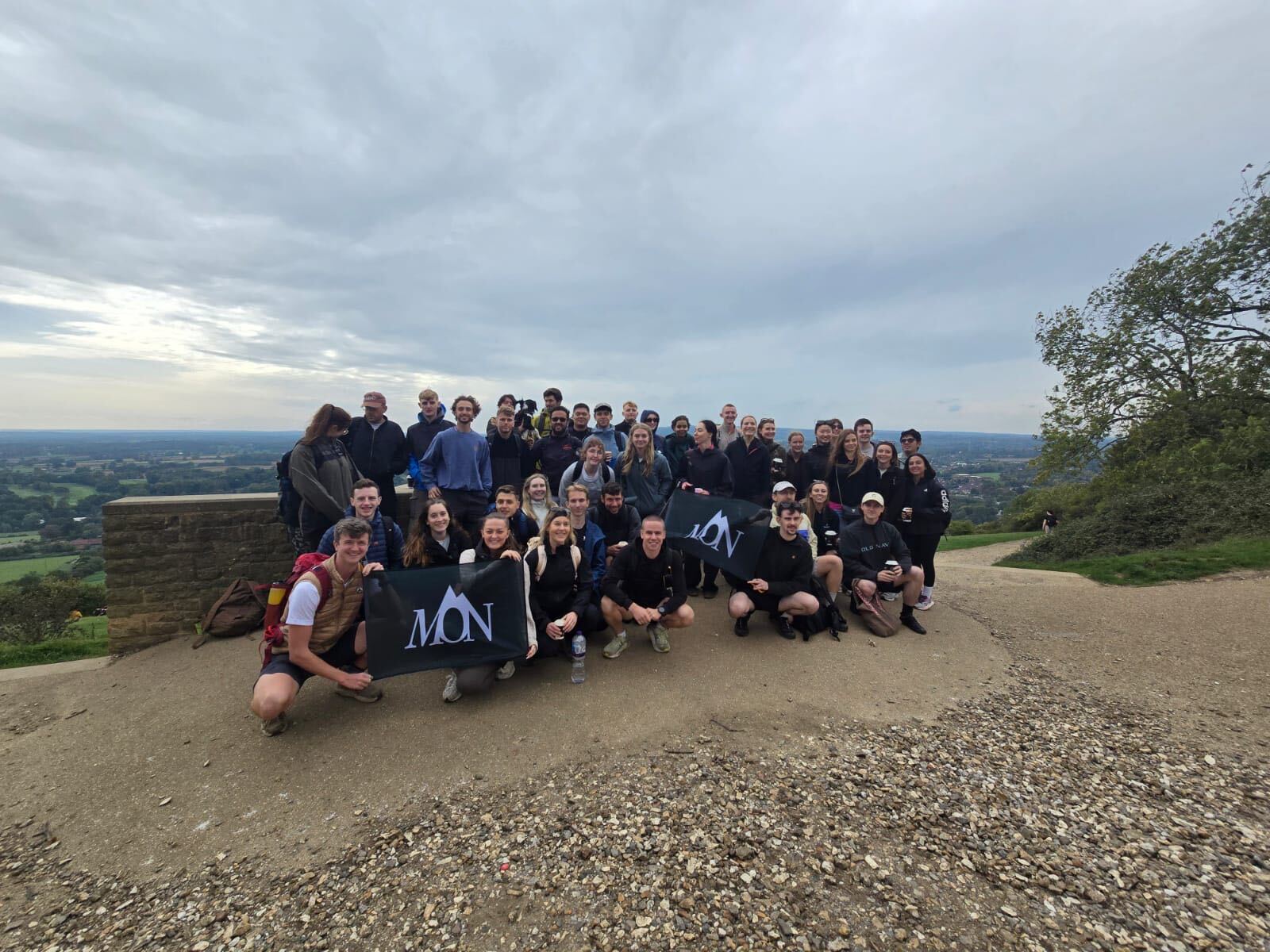 The Middle of Nowhere group together on a hilltop